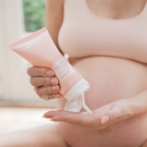 Pregnant woman applying Mamalove Belly Butter, highlighting the rich and creamy texture of the product. 